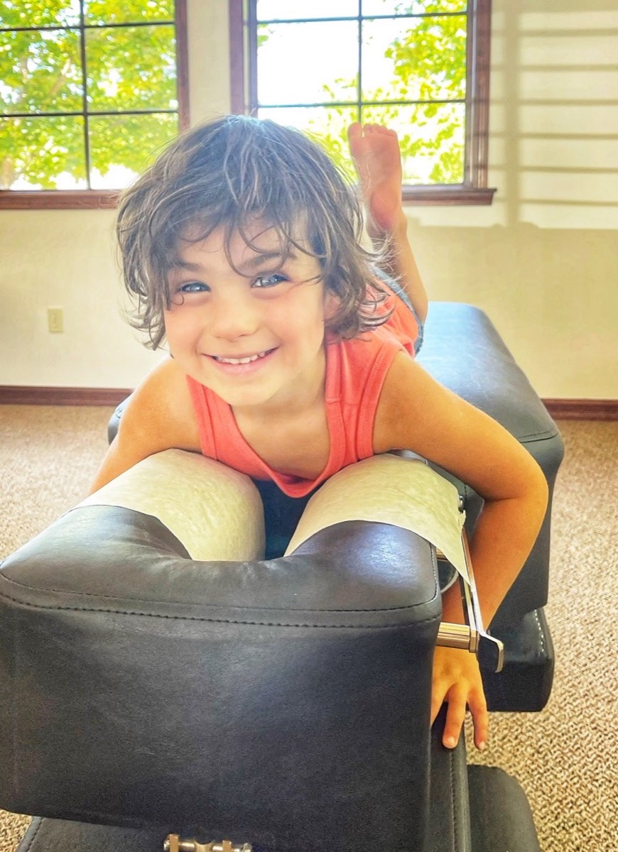 A smiling young patient on the adjusting table