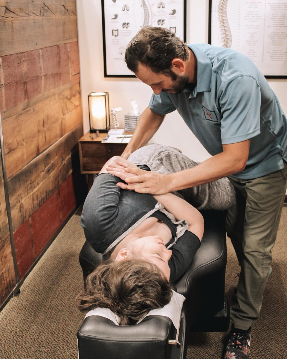 Dr. Austin Davis adjusting a patient at Life Chiropractic